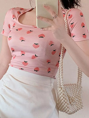 Pink square neck t-shirt with peach print, short sleeves, and ribbed texture.