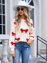 Cream knit pullover sweater with all-over red bow motif, crew neck, long sleeves.