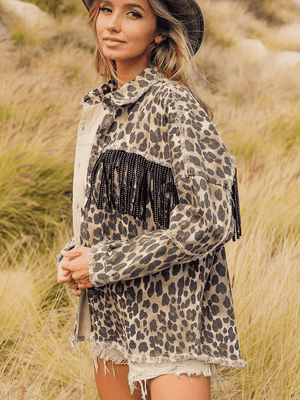 Leopard print denim jacket with black fringe embellishments and a collared neck.
