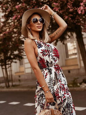Maxi dress with braided straps and a red and white leaf print, belted waist.