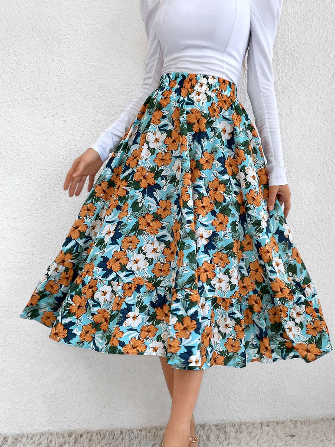 Tiered midi skirt with floral print and ruffled hem.