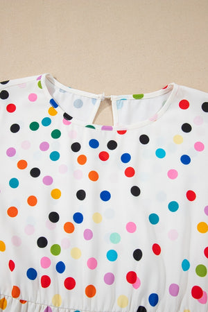 White polka dot blouse with flutter sleeves and keyhole back detail.