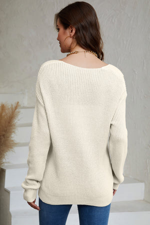 Relaxed knit V-neck pullover sweater in beige acrylic with a ribbed texture.