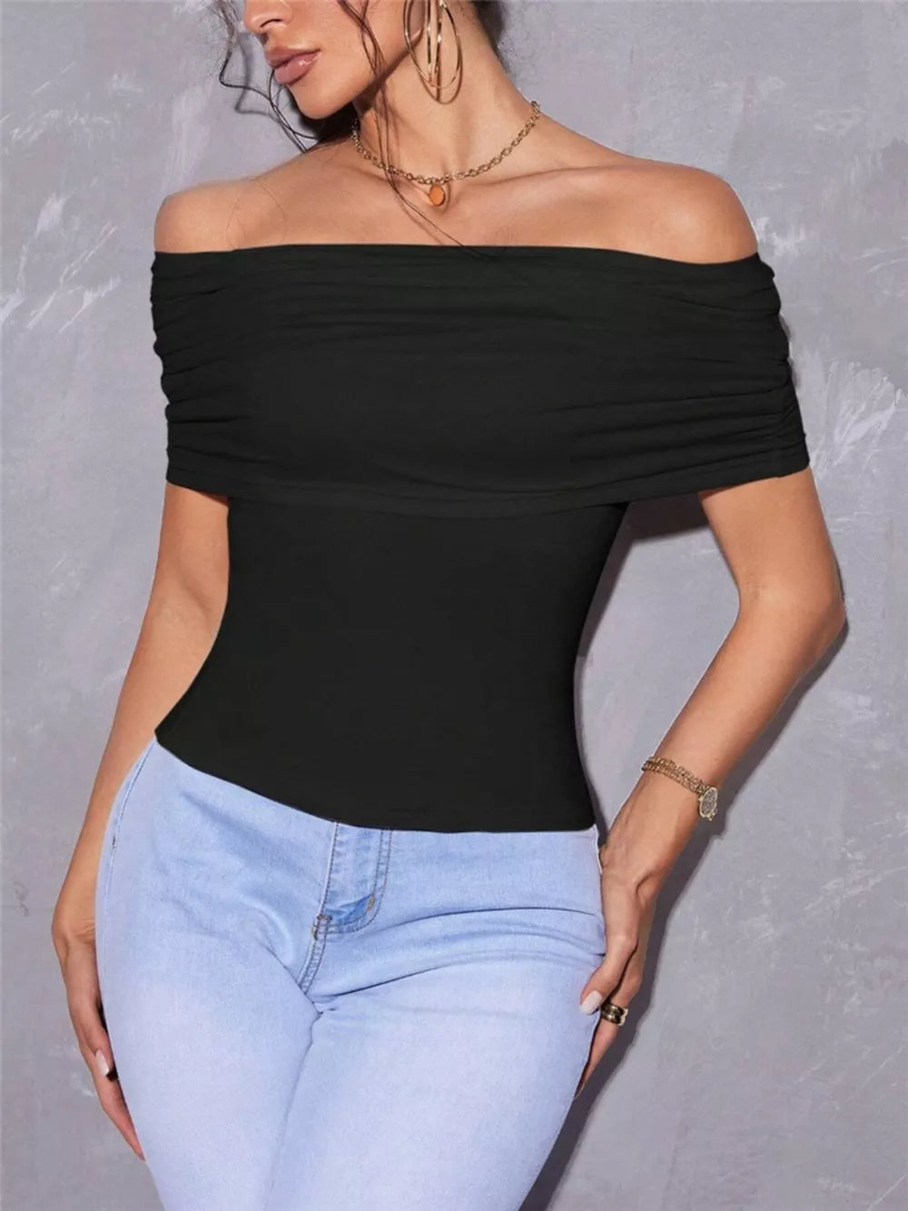 Black off-shoulder ruched t-shirt with short sleeves.