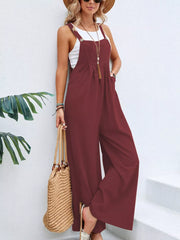 Burgundy wide-leg romper with pockets and buttoned straps, styled with a white tank.