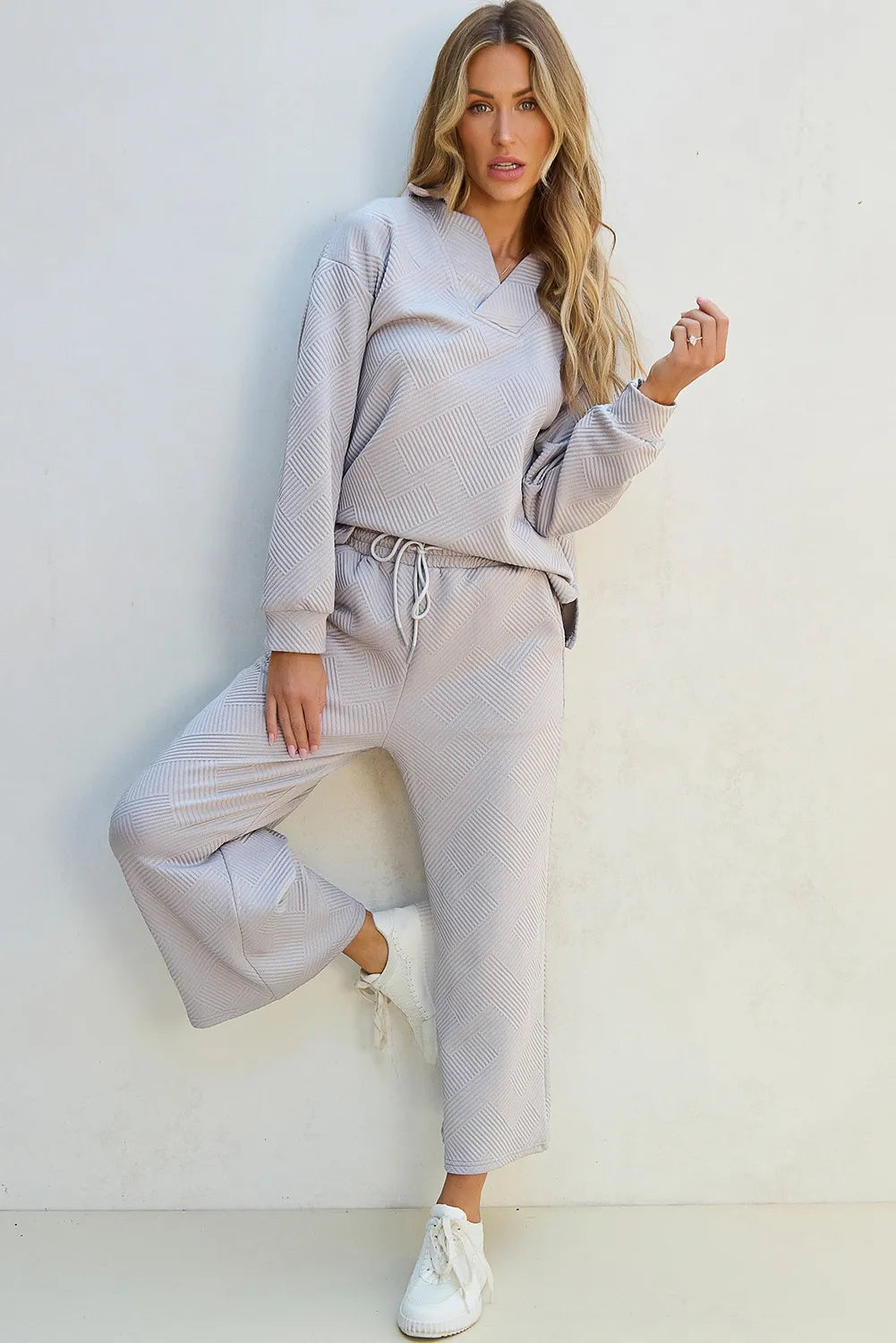 Gray quilted knit loungewear set with V-neck top and wide-leg pants.