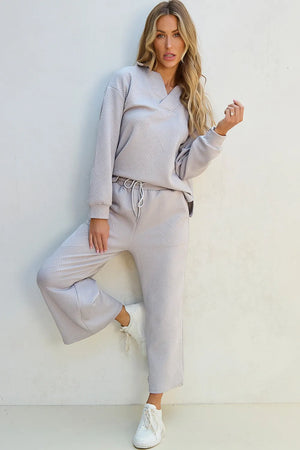 Gray quilted knit loungewear set with V-neck top and wide-leg pants.