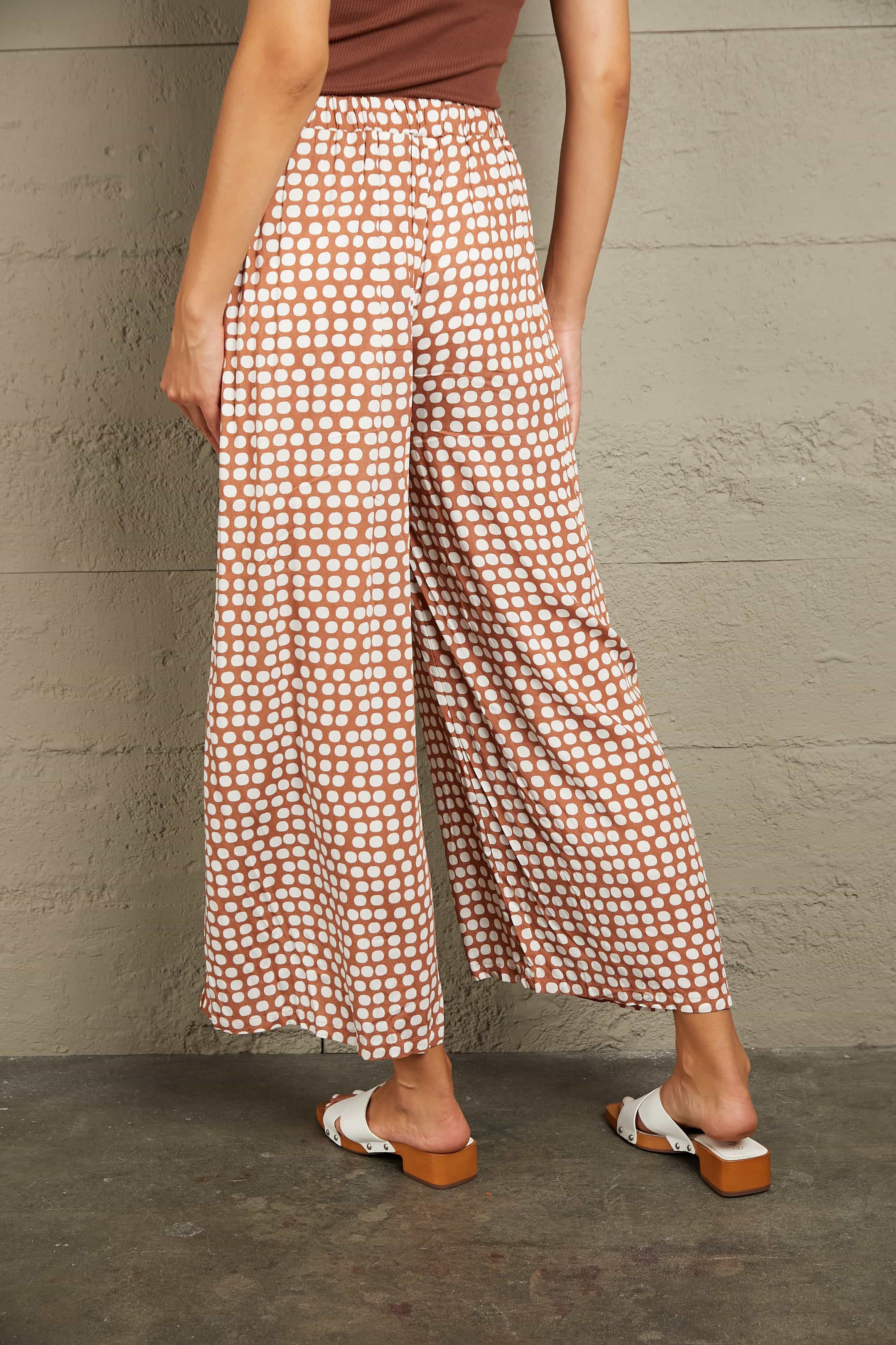 Polka dot wide leg culottes in brown with white dots, featuring an elastic waistband.