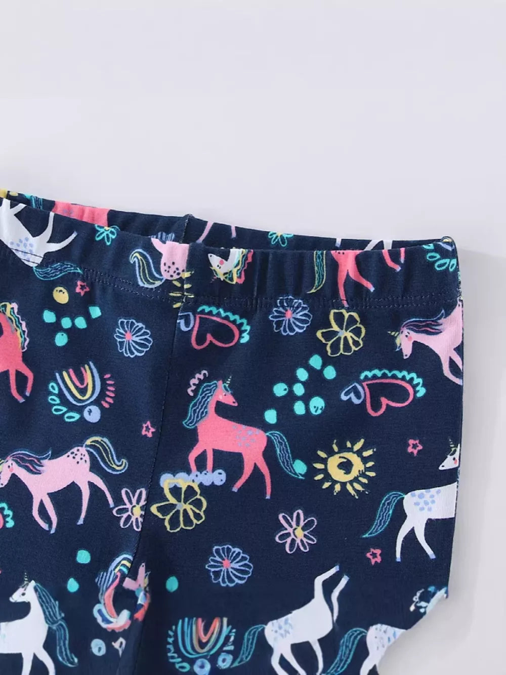 Navy cotton toddler leggings with a whimsical unicorn and flower print.