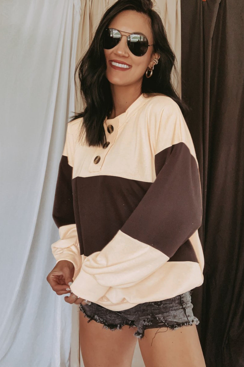 Colorblock henley sweatshirt with balloon sleeves in light yellow and dark brown, featuring a button placket.