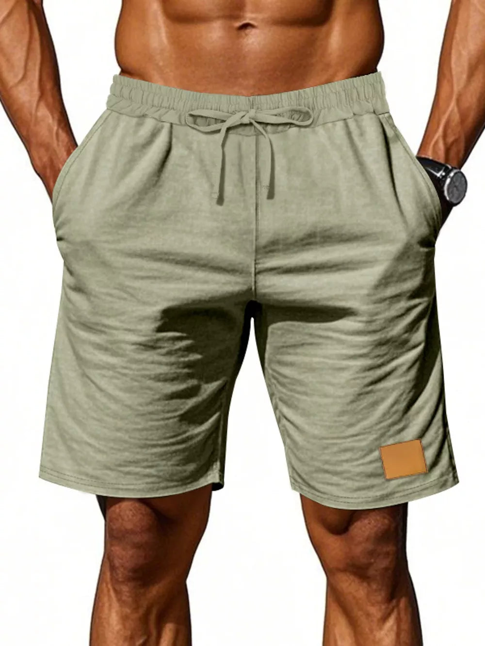 Light green chino shorts with drawstring waist and leather patch detail