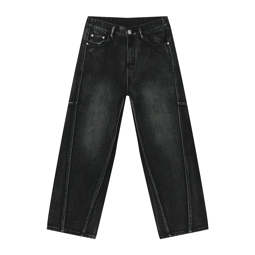 Dark wash denim trousers with exaggerated seam details and a wide leg.