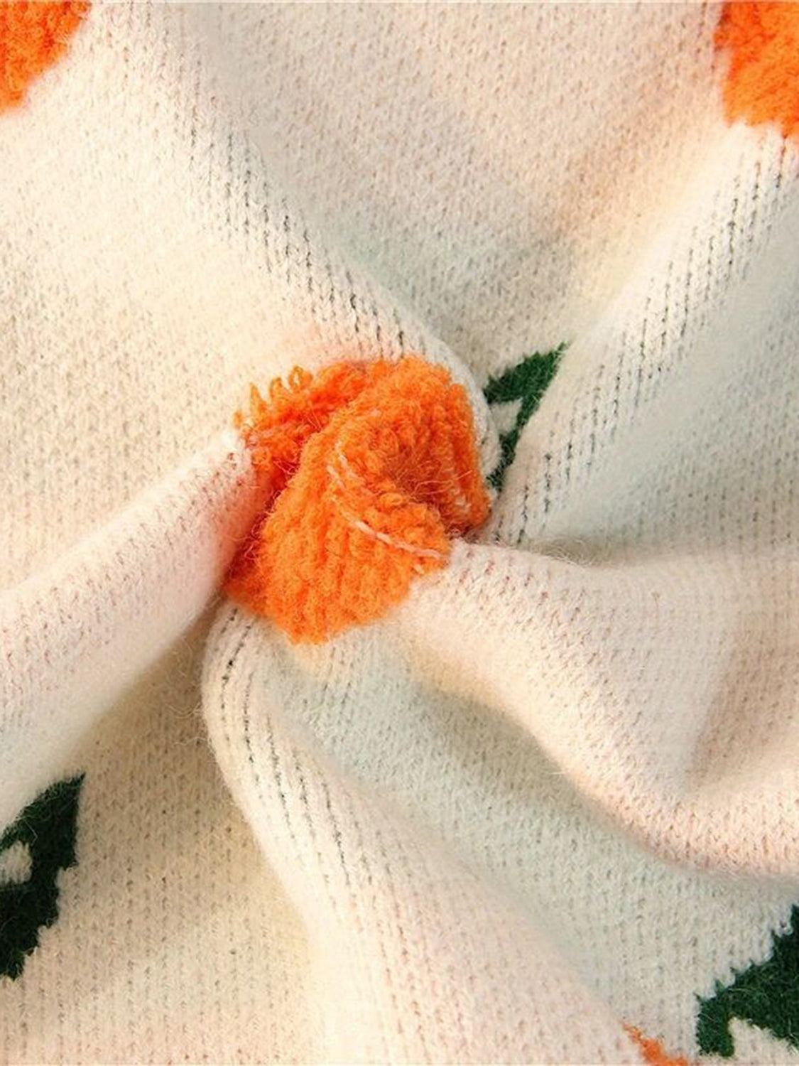 Cream acrylic knit sweater with orange and green orchard pattern detail.