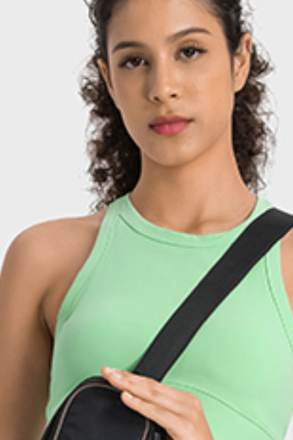 Sage green sculpted neckline crop top with a black strap detail.
