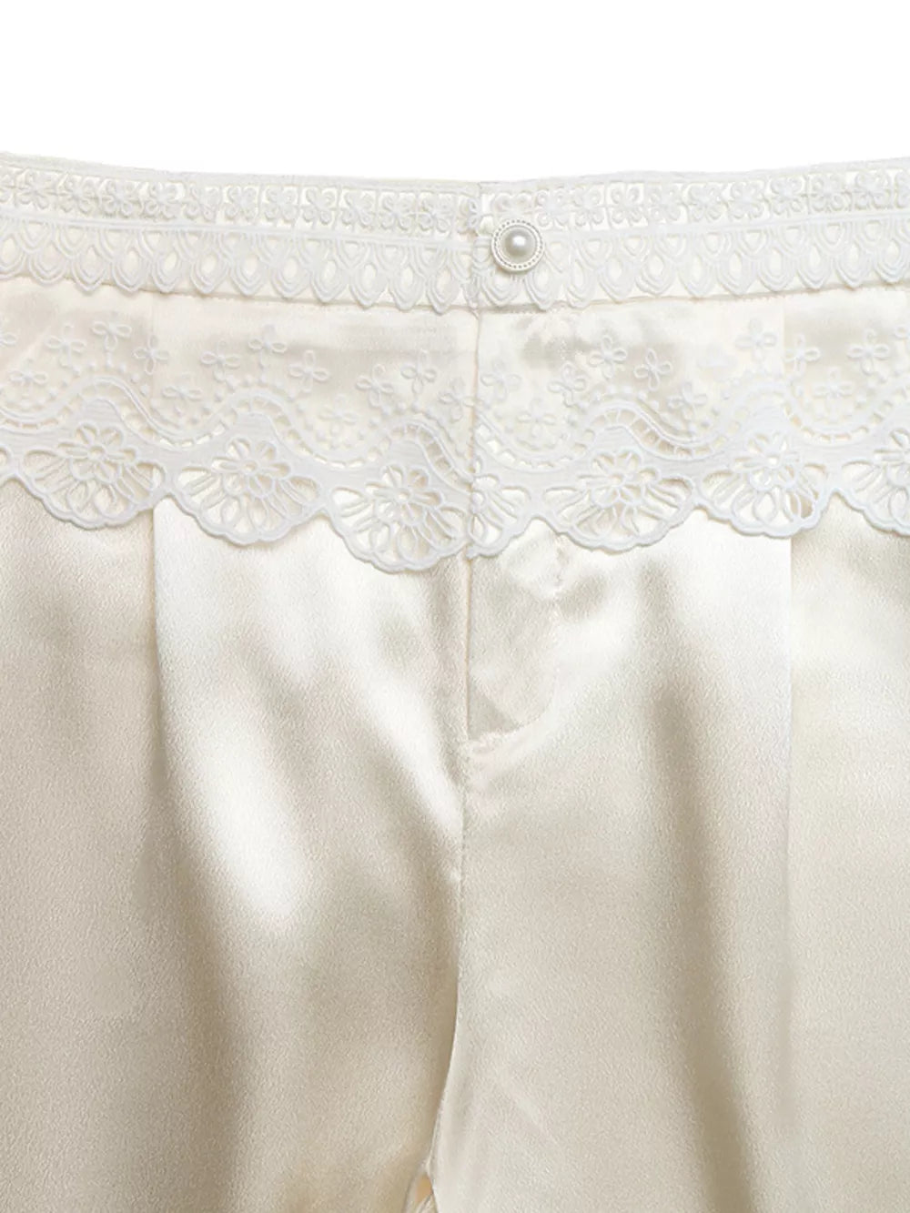 Lace-trimmed high-waist wide-leg pants in beige satin with a pearl button closure.