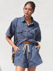 Relaxed denim shirt and drawstring shorts set in medium wash with button front and dual chest pockets.