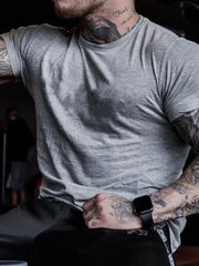 Gray crew neck t-shirt with short sleeves and a muscle fit.