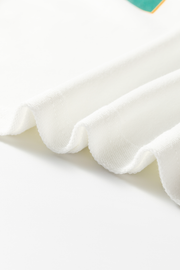 White raglan sleeve sweatshirt fabric detail, showing textured knit and soft drape.