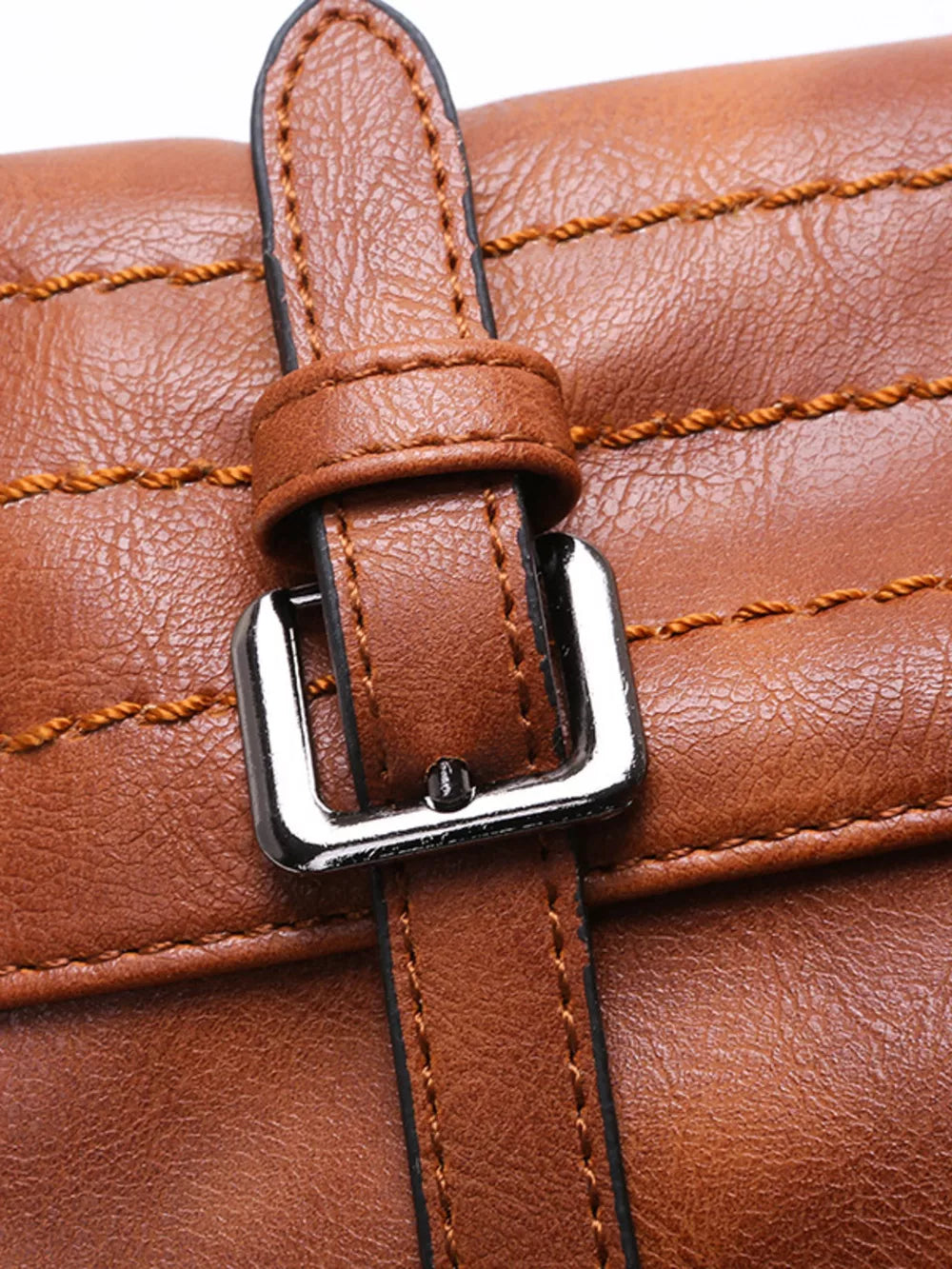 Brown leather half-moon bag with decorative stitching and silver buckle detail.