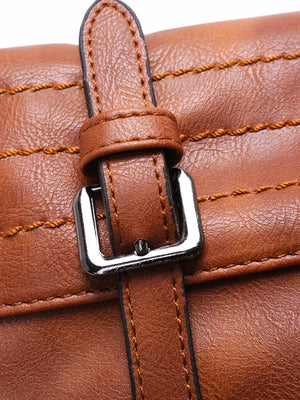 Brown leather half-moon bag with decorative stitching and silver buckle detail.