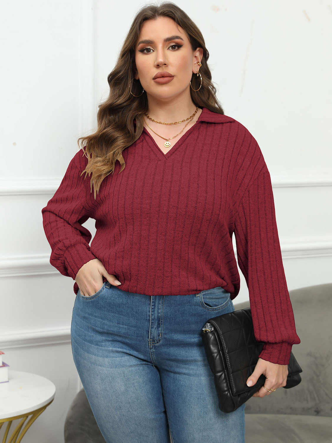 Relaxed ribbed polo top in Brick Red with a V-neck and long sleeves.