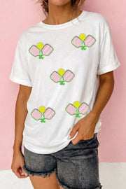 White cotton t-shirt with playful sequin pickleball applique details.