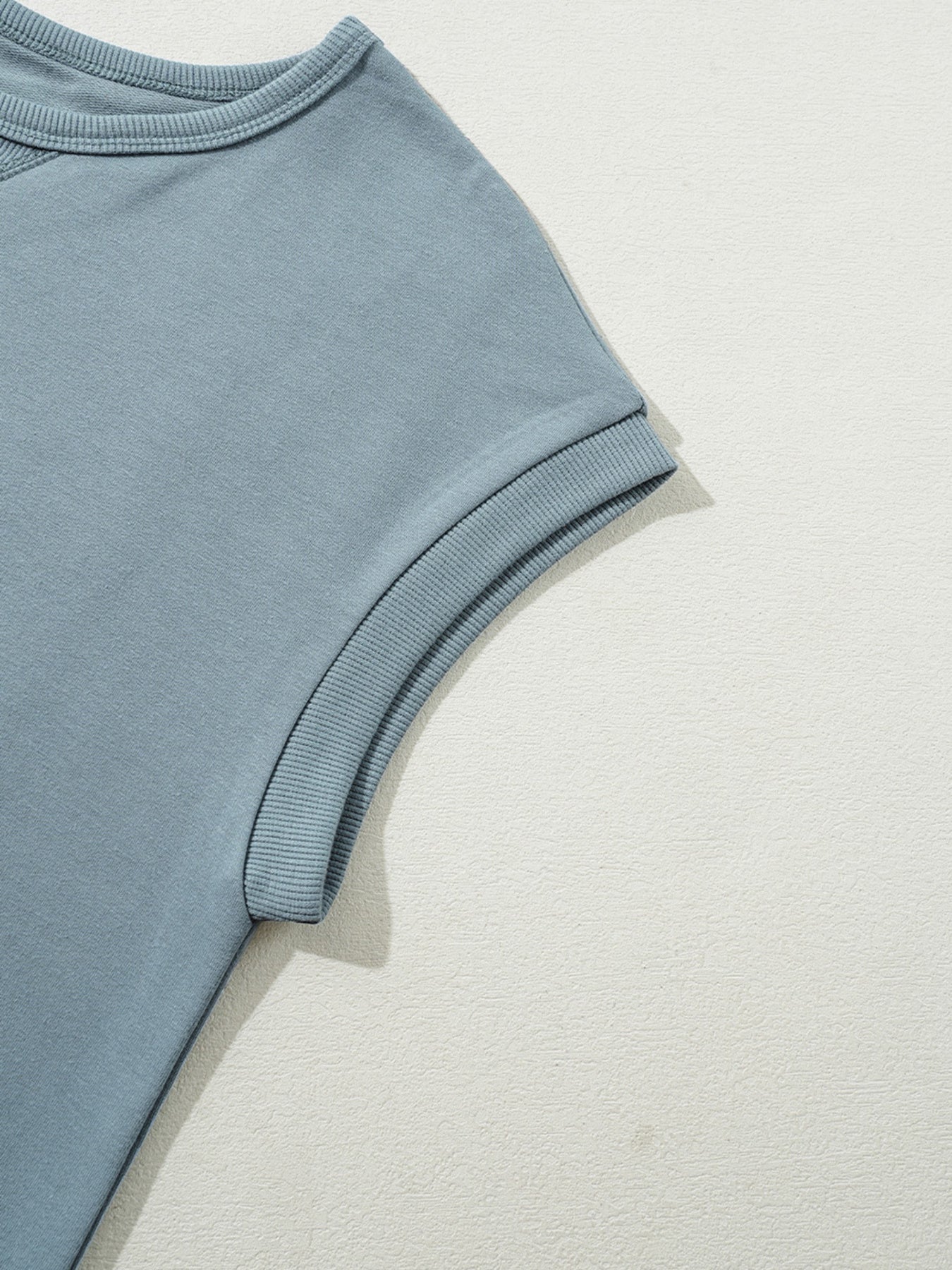 Cap sleeve t-shirt dress in French blue cotton with ribbed cuffs.