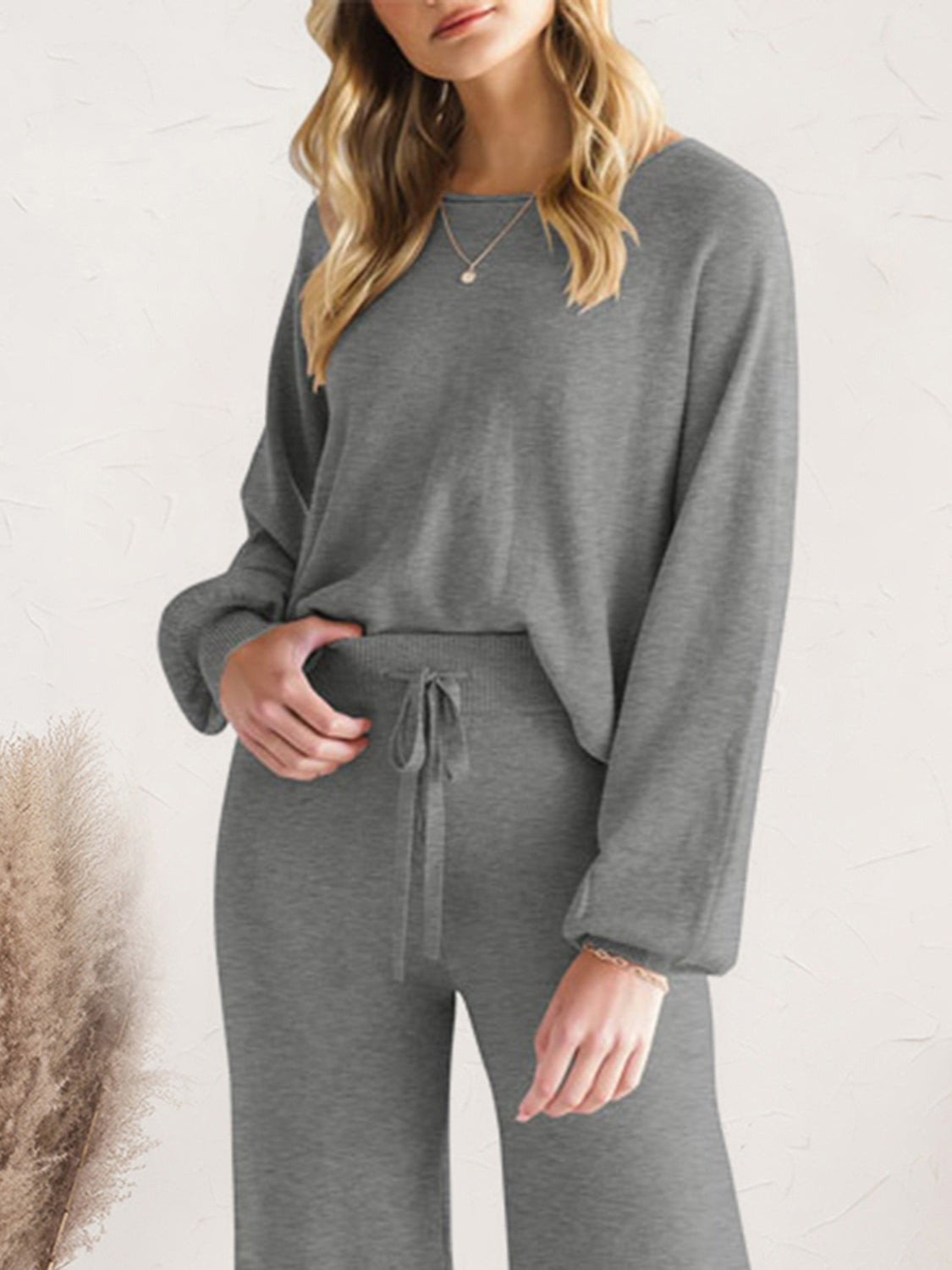 Dark gray acrylic loungewear set with wide-leg pants and a crewneck sweater.
