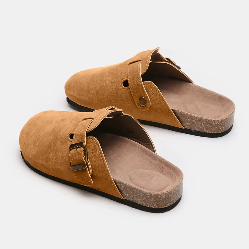 Camel suede clog slides with adjustable buckle and cork sole.