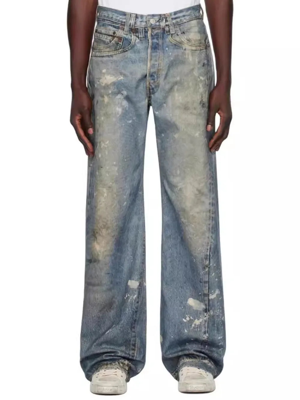 Distressed wide-leg jeans in medium wash denim with painterly splatters and a worn look.