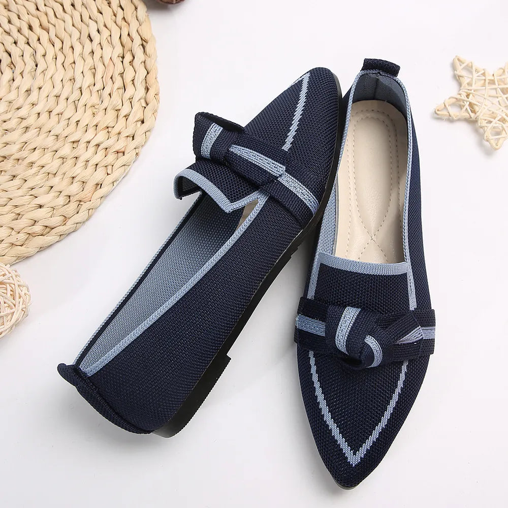 Mesh pointe slip-ons flats in dark navy with light blue trim and bow detail.