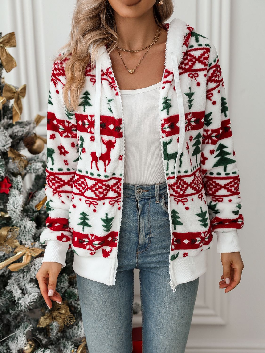 White fleece zip-up hoodie with festive Fair Isle pattern of deer and trees.