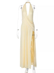 Yellow ruched halter neck maxi dress with a deep V-neck and high slit