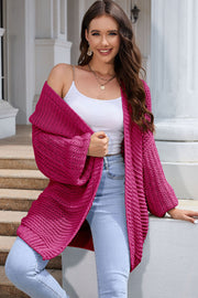 Hot Pink textured knit cocoon cardigan with balloon sleeves and open front.