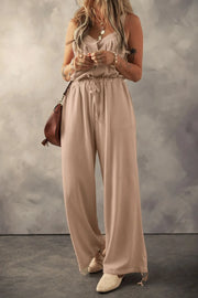 Waffle knit wide leg jumpsuit in khaki with button front and drawstring waist.