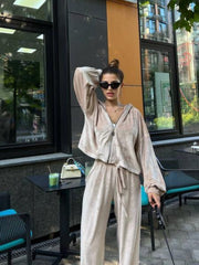 Plush velour lounge set in Sand, featuring a zip-up hoodie and wide-leg pants with drawstring.