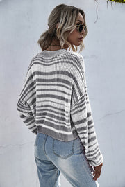 Cropped stripe knit crew neck sweater in black and white, featuring a relaxed fit and crew neckline.
