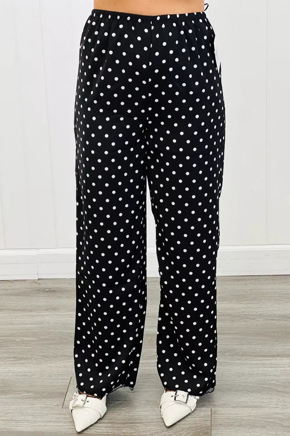 Chic polka dot wide-leg maternity trousers in black with white dots.