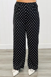 Chic polka dot wide-leg maternity trousers in black with white dots.