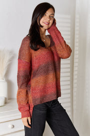 Sunset Stripe Slouchy V-Neck Knit sweater in brick red with ombre stripes and ribbed cuffs.