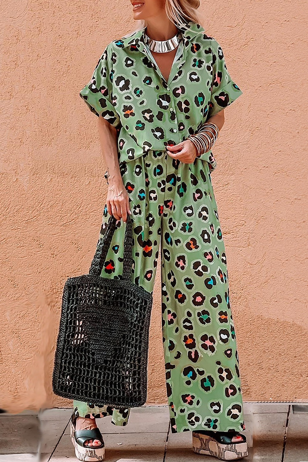 Leopard print resort shirt and wide leg trousers set in sage green with colorful accents.