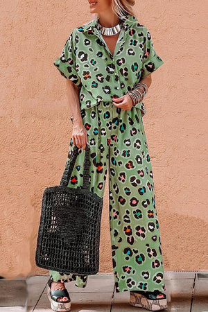 Leopard print resort shirt and wide leg trousers set in sage green with colorful accents.