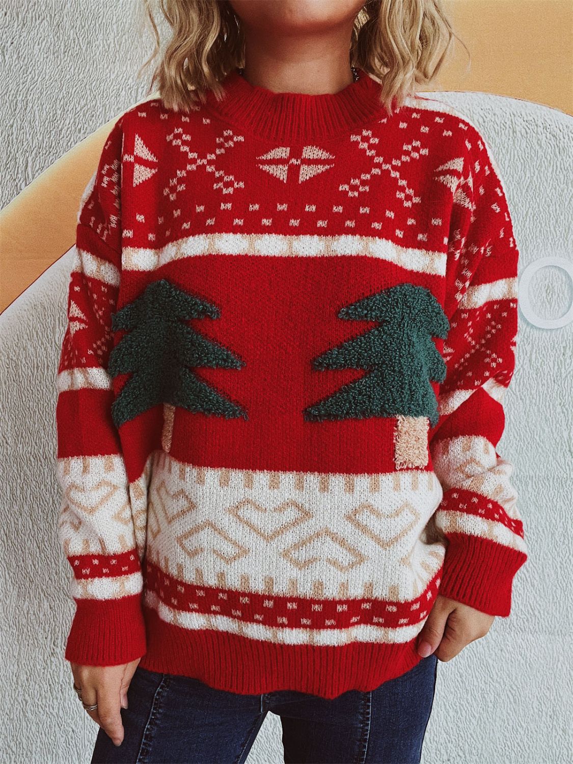 Festive red knit sweater with appliqué trees and Fair Isle pattern.