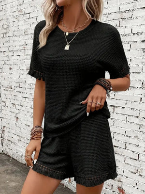 Black textured knit set with fringe trim on sleeves and shorts.