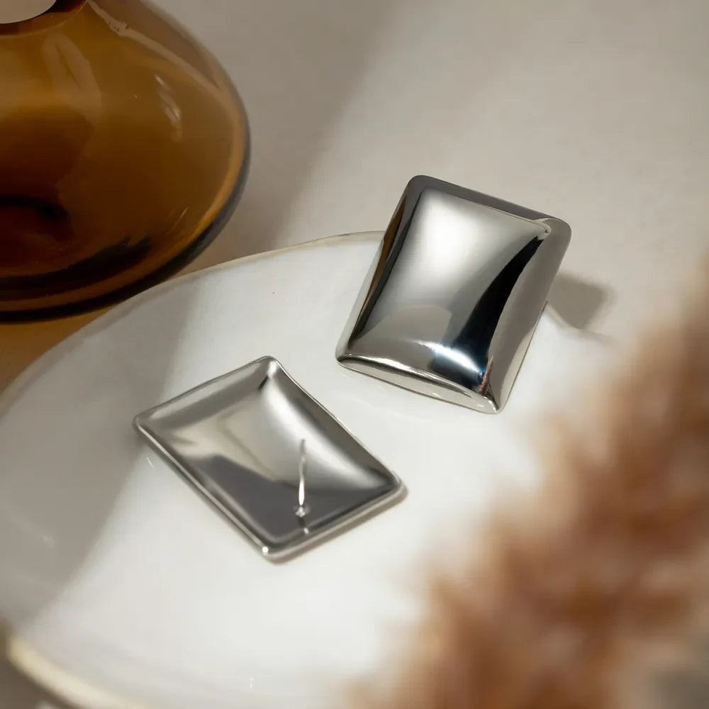 Sculpted silver rectangle earrings with a polished finish.