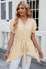 Light Yellow Dotted Swiss blouse with lace trim V-neck, short puff sleeves, belted waist, and asymmetric hem.