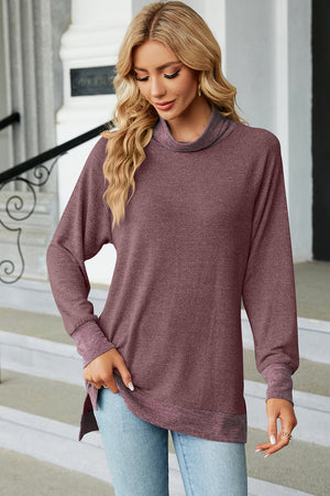 Colorblock raglan turtleneck tunic in a deep purple heathered knit with contrasting cuffs and hem.