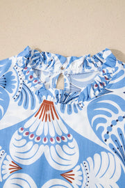 Blue and white botanic print dress with ruffled neckline and keyhole back detail.