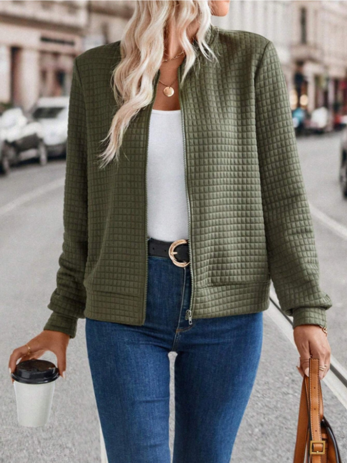 Army green quilted bomber jacket with zip closure and pockets.