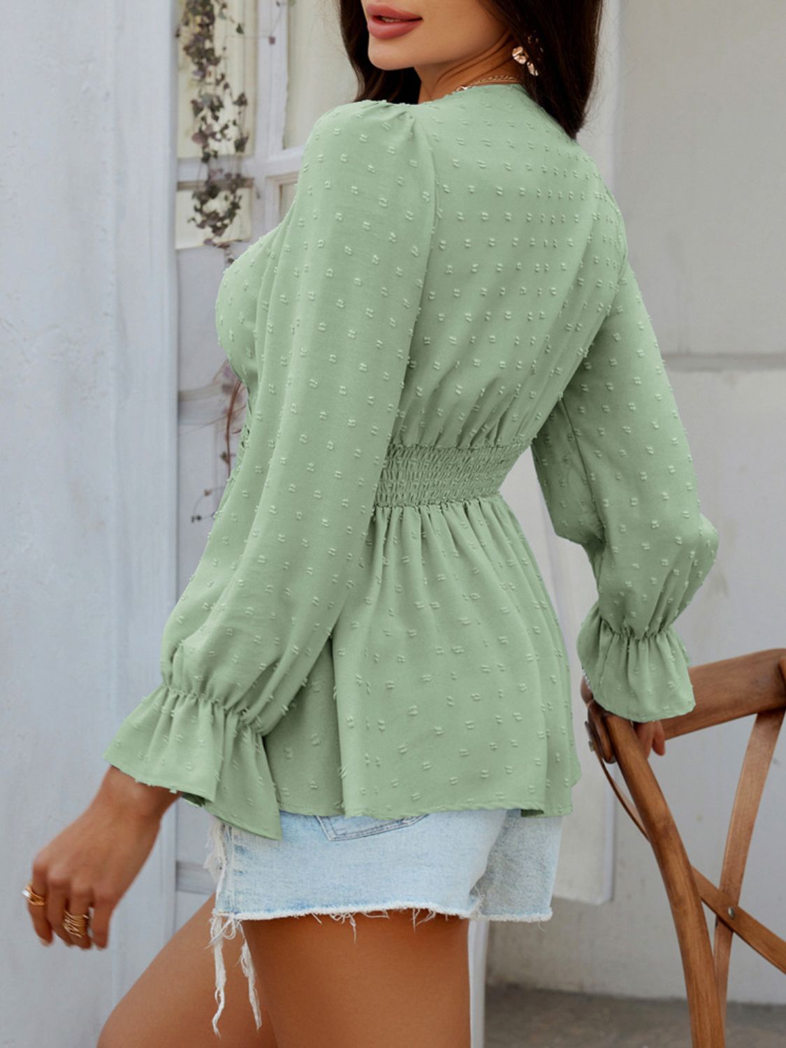 Gum Leaf Swiss dot blouse with smocked waist and ruffled cuffs.